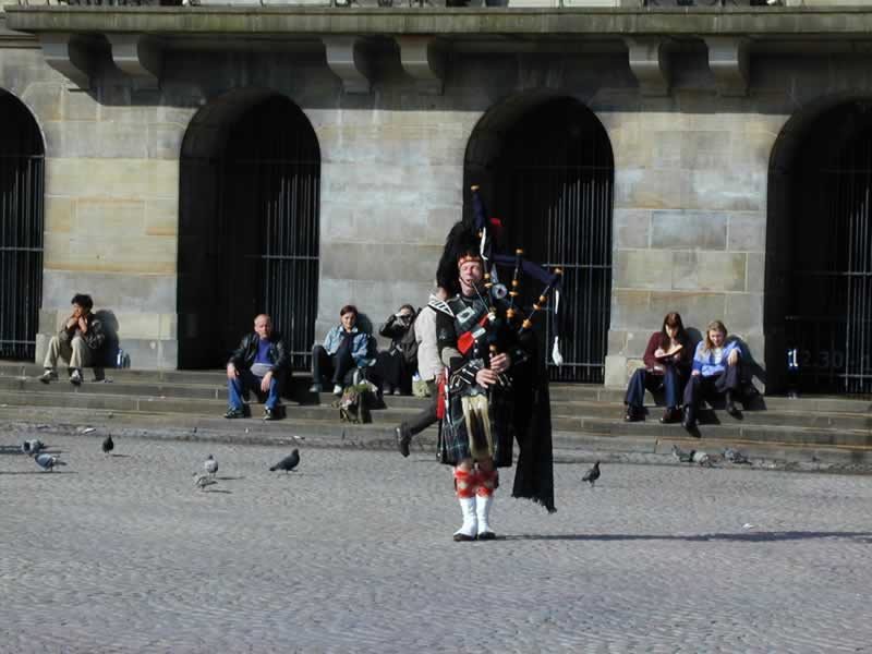 Scottish bagpipper in Square